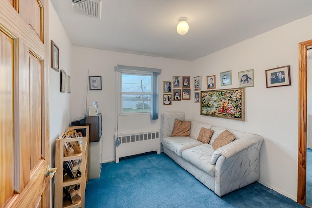 interior space featuring radiator heating unit, carpet, visible vents, and baseboards