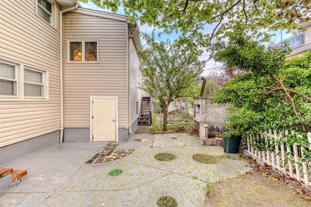 view of patio / terrace with stairs and fence