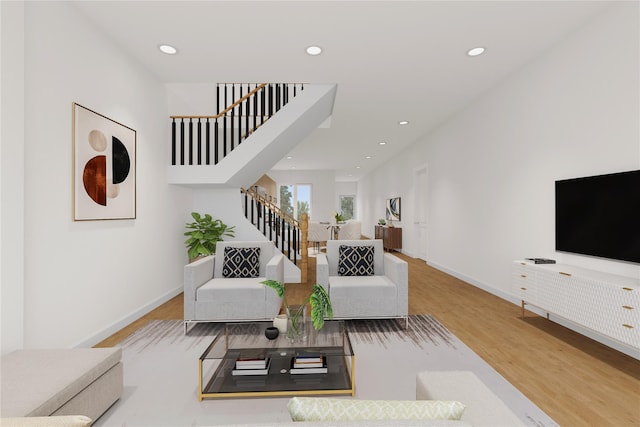 living area featuring recessed lighting, stairway, baseboards, and wood finished floors