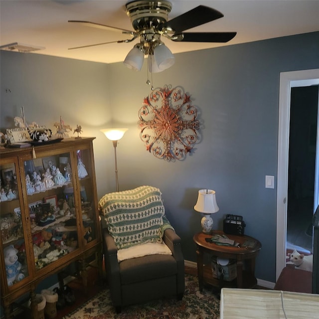 living area with ceiling fan