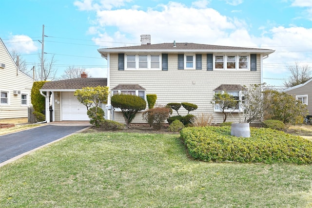 view of front of property featuring aphalt driveway, a front yard, roof with shingles, a chimney, and an attached garage