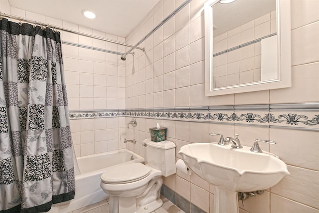 bathroom with toilet, tile walls, and shower / bathtub combination with curtain