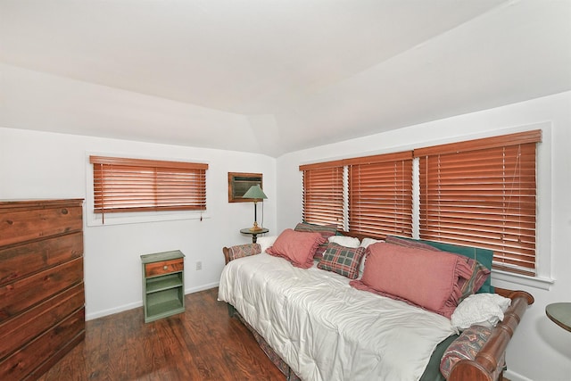 bedroom with lofted ceiling, wood finished floors, and baseboards