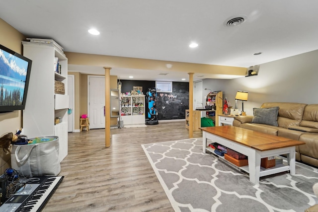 living room featuring recessed lighting, visible vents, and light wood-style flooring