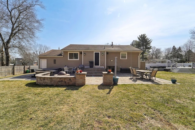 back of property featuring fence, a lawn, and a patio area