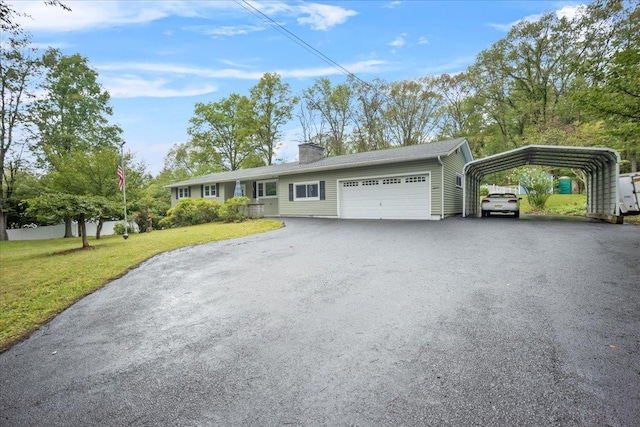 ranch-style home with a front lawn, aphalt driveway, a chimney, a garage, and a carport