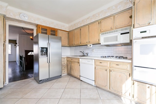 kitchen featuring light countertops, light tile patterned floors, white appliances, a warming drawer, and a sink