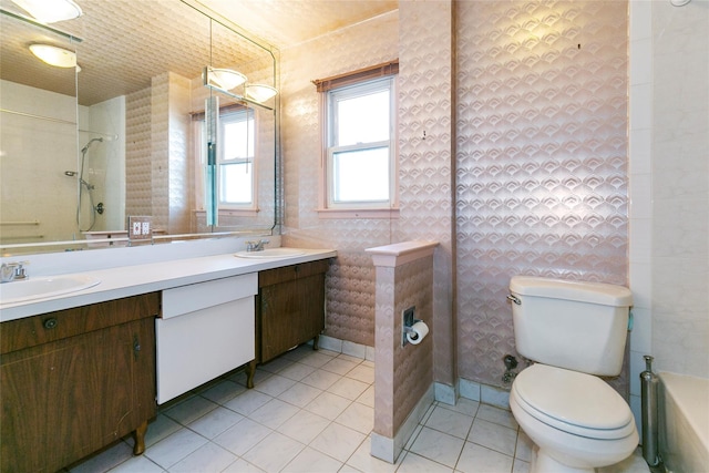 full bathroom with walk in shower, double vanity, toilet, and a sink