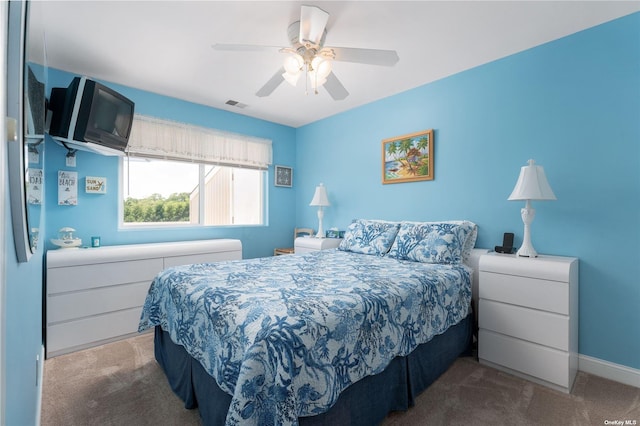 bedroom featuring visible vents, baseboards, ceiling fan, and carpet floors