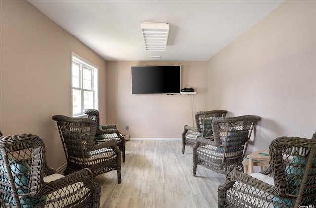 sitting room featuring baseboards and wood finished floors