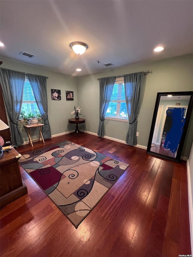 sitting room with visible vents, baseboards, and wood finished floors