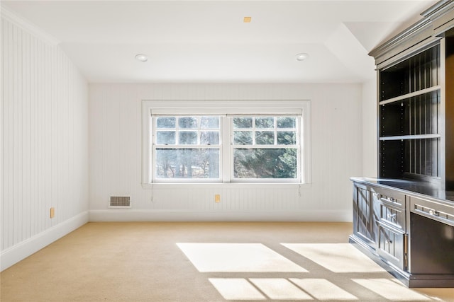 carpeted spare room with baseboards and visible vents