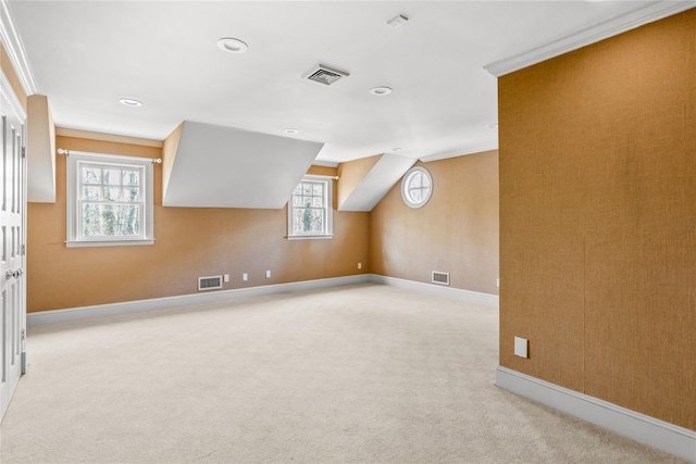 bonus room with visible vents, baseboards, and light colored carpet