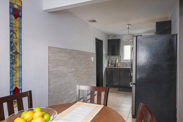 dining area featuring light tile patterned floors and visible vents