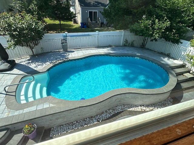 view of pool featuring a fenced in pool, a patio, fence, and entry steps