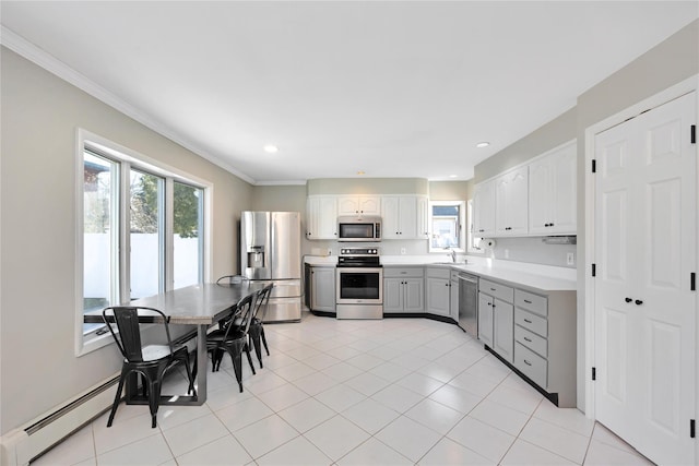 kitchen featuring gray cabinets, a sink, stainless steel appliances, light countertops, and a baseboard radiator