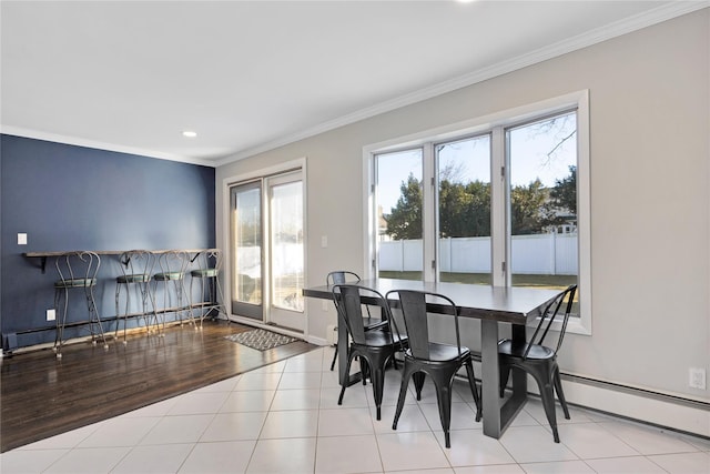 dining space featuring wood finished floors, baseboards, a baseboard radiator, recessed lighting, and ornamental molding