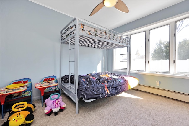 carpeted bedroom with baseboards, a ceiling fan, and a baseboard radiator