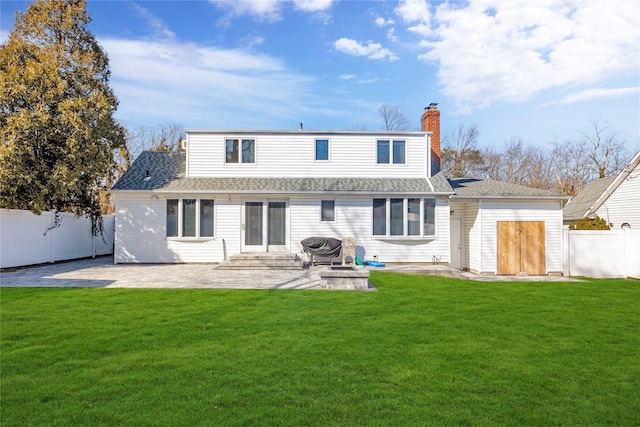 back of house with a patio, a lawn, a fenced backyard, and entry steps