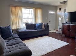 living room featuring stairs and wood finished floors