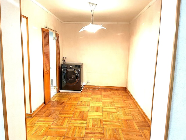 laundry area featuring washer / dryer, ornamental molding, baseboards, and laundry area