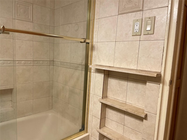 full bath featuring bath / shower combo with glass door