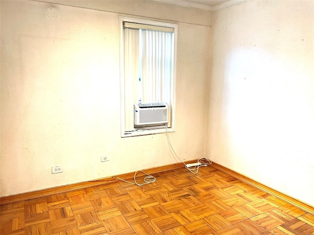 unfurnished room with cooling unit and baseboards