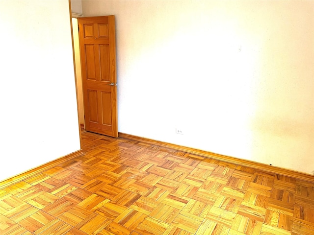 unfurnished room with baseboards