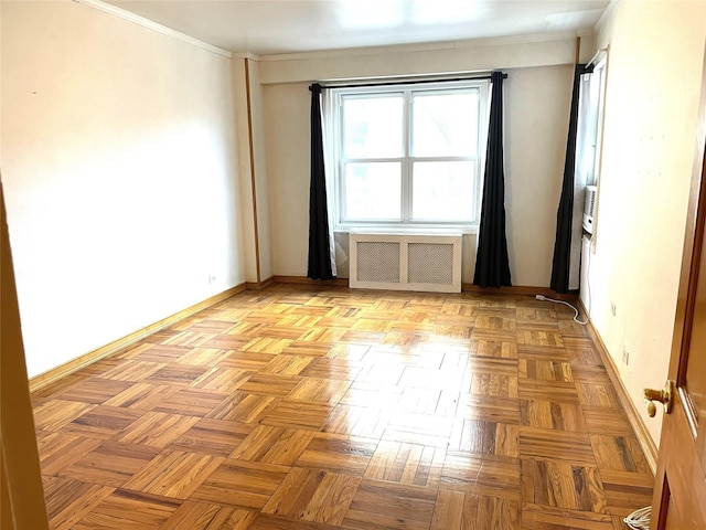 spare room featuring radiator heating unit, baseboards, and ornamental molding