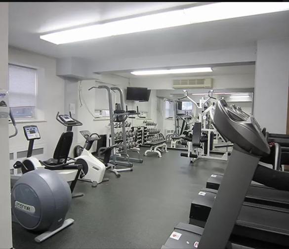 gym featuring a wall mounted air conditioner