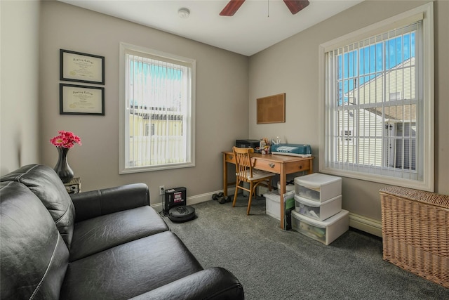 carpeted office space featuring a wealth of natural light, baseboards, and ceiling fan