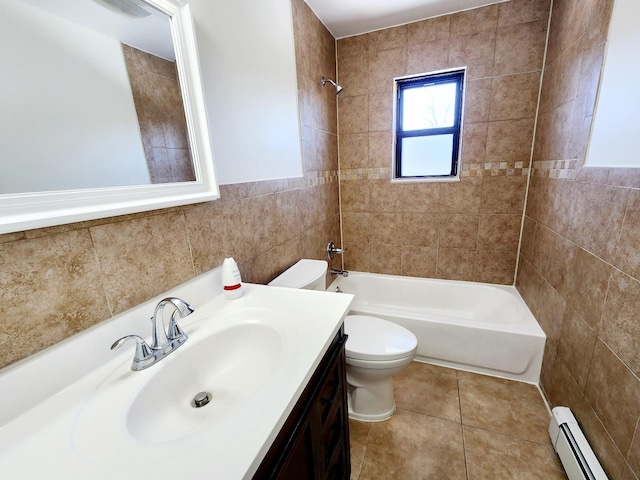 full bathroom featuring toilet, vanity, baseboard heating, bathtub / shower combination, and tile walls