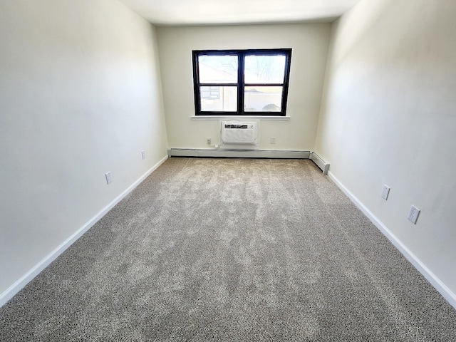 empty room with carpet flooring, a baseboard heating unit, and baseboards