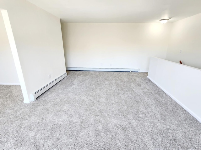 spare room with carpet flooring and a baseboard radiator