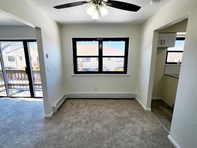 interior space featuring a baseboard heating unit and baseboards