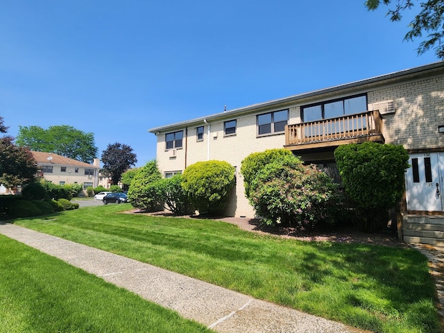 196 Sneden Pl Unit 196, Spring Valley, NY 10977 - rear view of house featuring brick siding and a yard