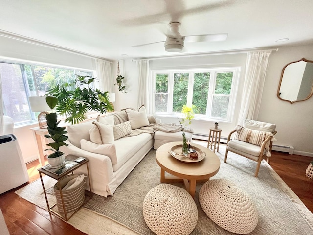 living room featuring wood finished floors, ceiling fan, and plenty of natural light