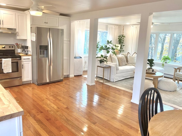 kitchen featuring appliances with stainless steel finishes, ceiling fan, a wealth of natural light, and under cabinet range hood