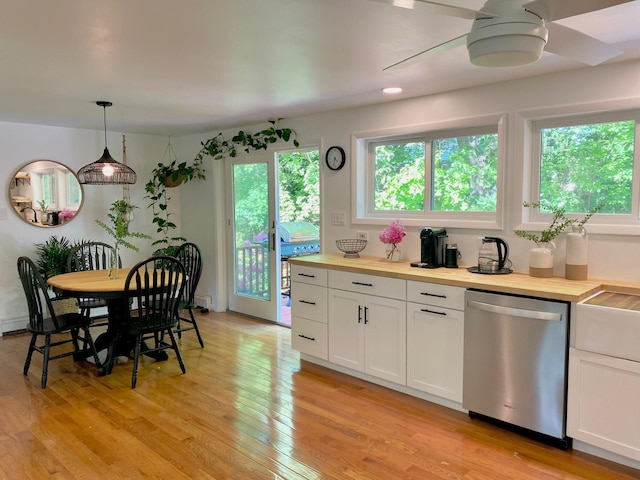 kitchen with stainless steel dishwasher, butcher block counters, white cabinets, and a ceiling fan
