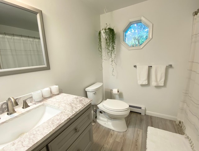 full bathroom with vanity, baseboard heating, baseboards, toilet, and wood finished floors