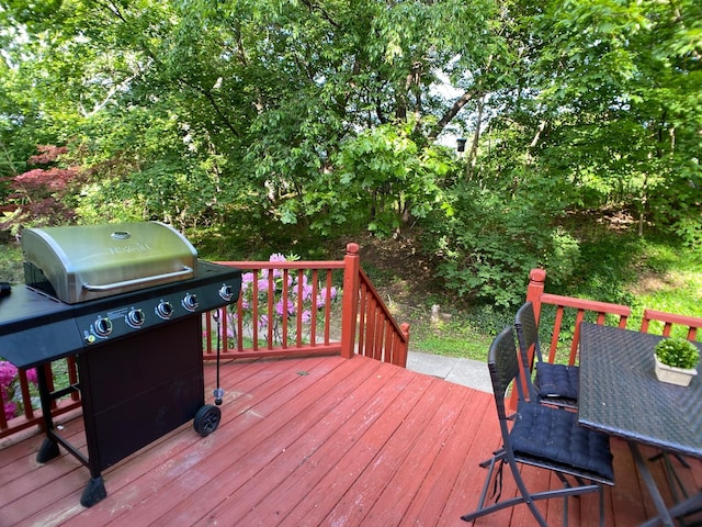 wooden deck featuring a grill