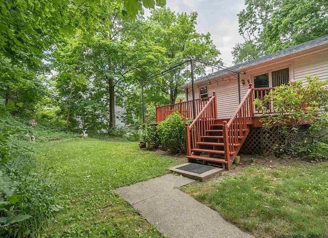 view of yard featuring a deck and stairway
