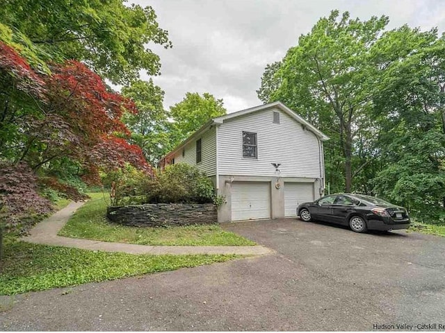 view of home's exterior with driveway and an attached garage