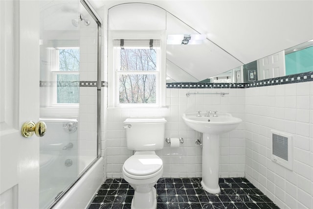 33 N Way, Chappaqua, NY 10514 - full bath featuring heating unit, toilet, tile walls, bath / shower combo with glass door, and a sink