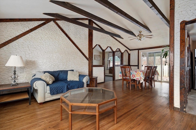 living area with ceiling fan, beamed ceiling, high vaulted ceiling, and wood finished floors