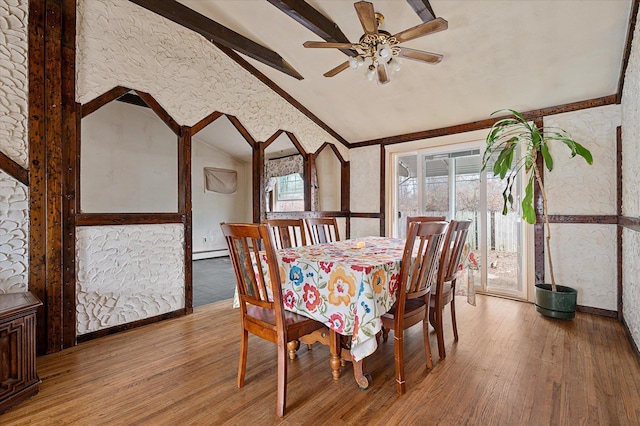 dining area with a baseboard heating unit, vaulted ceiling with beams, light wood-style floors, and a ceiling fan