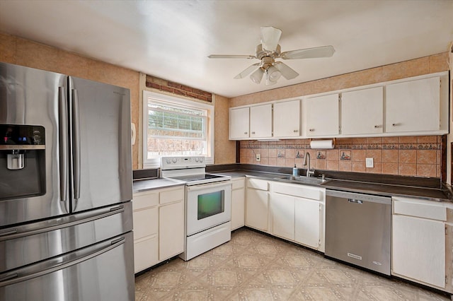 kitchen featuring a sink, stainless steel appliances, light floors, and backsplash