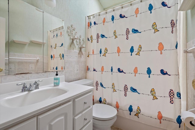 bathroom with tasteful backsplash, tile walls, shower / bath combo with shower curtain, toilet, and vanity