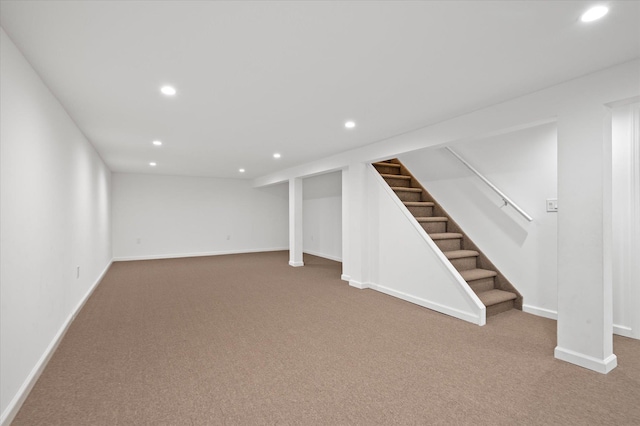 finished basement featuring recessed lighting, stairway, baseboards, and carpet flooring