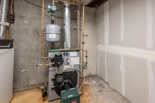 utility room featuring washer / dryer and a heating unit